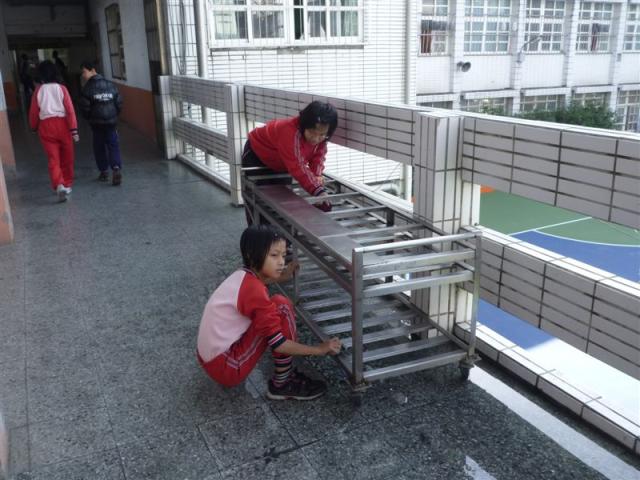 第四棟二樓走廊上認真打掃的小朋友